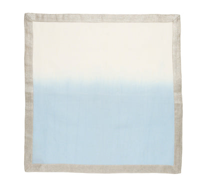 The Kim Seybert Dip Dye Napkin Set features square cloth napkins with a light beige border and a hand-dipped gradient that fades from off-white to light blue—perfect for elevating your table with elegant ombre style.