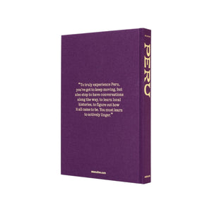 A purple hardcover book titled "Peru, An Odyssey Across a Time Honored Land" by Assouline features an inspirational Peru travel quote on the front cover in white text.