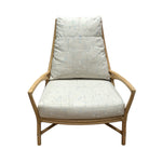 The Petal Lounge Chair by McGuire Furniture features a sculptural wooden frame with light, patterned cushions on the seat and backrest, making it a statement piece shown against a white background.