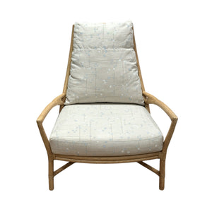 The Petal Lounge Chair by McGuire Furniture features a sculptural wooden frame with light, patterned cushions on the seat and backrest, making it a statement piece shown against a white background.