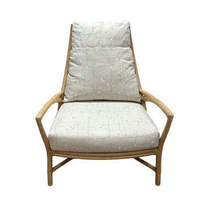The Petal Lounge Chair by McGuire Furniture features a sculptural wooden frame with light, patterned cushions on the seat and backrest, making it a statement piece shown against a white background.
