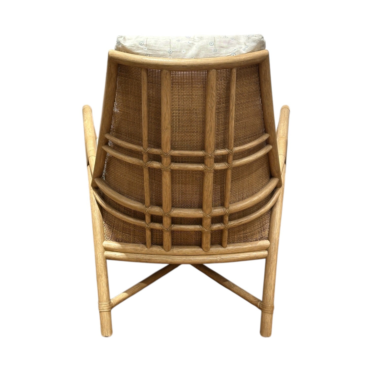 The Petal Lounge Chair by McGuire Furniture features a sculptural curved wood and rattan backrest, woven cane accents, and a light cushion, shown from the back against a white background.