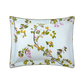A rectangular pillowcase from Yves Delorme’s Luciole Bedding Collection, made of organic cotton sateen, features green leaves and pink flowers on a light blue background.