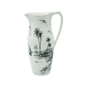 Tall ceramic pitcher with handle from Gien France’s Depareillees Vert Collection, featuring a black and white tropical landscape with palm trees, sailboat, and birds—an elegant table decor piece.