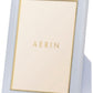 A rectangular Piero Leather Frame from AERIN in light blue with gold detailing and a stand—an elegant way to showcase your cherished memories.