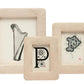 The Ancona Frame Collection by Pigeon & Poodle features three beige textured frames in a subtle spiral weave, displaying black and white art—a harp, a decorative "P," and an ornate "R"—to elegantly preserve cherished memories.