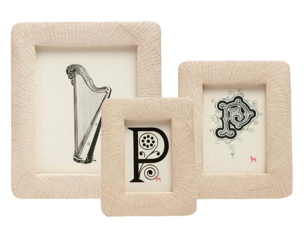 The Ancona Frame Collection by Pigeon & Poodle features three beige textured frames in a subtle spiral weave, displaying black and white art—a harp, a decorative "P," and an ornate "R"—to elegantly preserve cherished memories.
