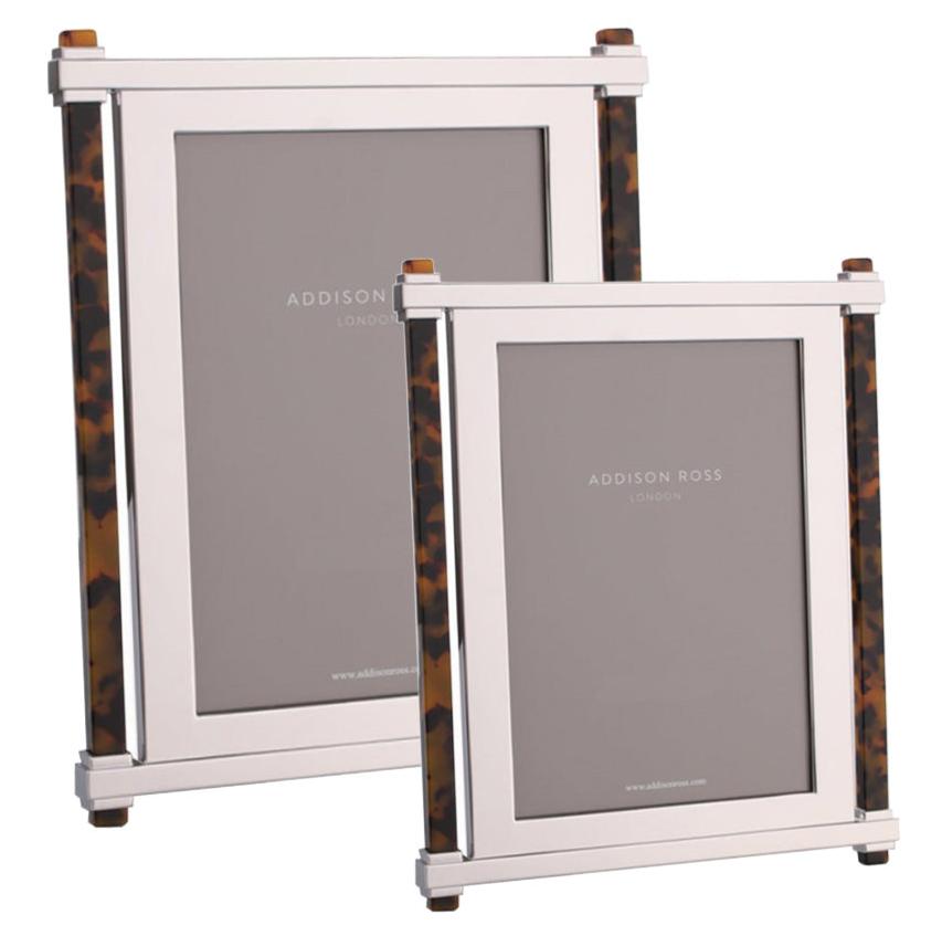 Two Addison Ross Faux Tortoise Pillar & Silver Frames, one large and one small, stand elegantly side by side, each featuring tortoise acrylic accents and soft velvet backstands from the coveted collection.
