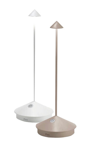 The Zafferano Pina Lamp Collection by Zafferano America includes two modern, portable lamps with triangular bases and conical shades in white and beige. These cordless, rechargeable lamps feature touch sensors on the base, ideal for indoor and outdoor use.