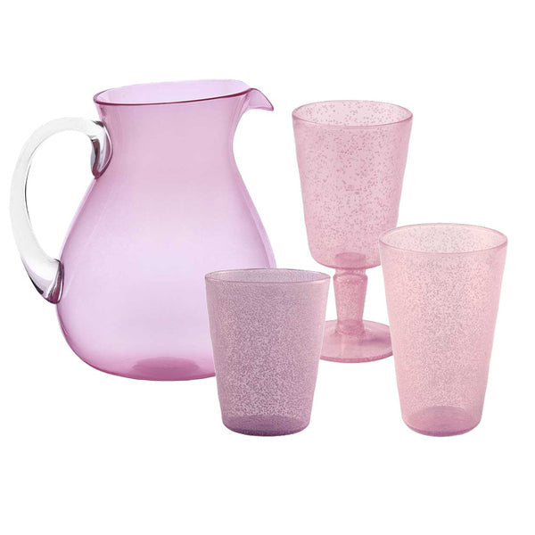 The Memento Acrylic Drinkware Collection in pink includes a pitcher, two cups, and a stemmed glass on a white background. Ideal for elegant outdoor dining, these translucent acrylic pieces from Memento combine functionality with style.