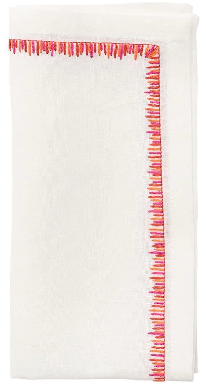 The Filament Napkin Set by Kim Seybert includes crisp white napkins, each neatly folded and accented with delicate pink and orange embroidered stitching along one edge.