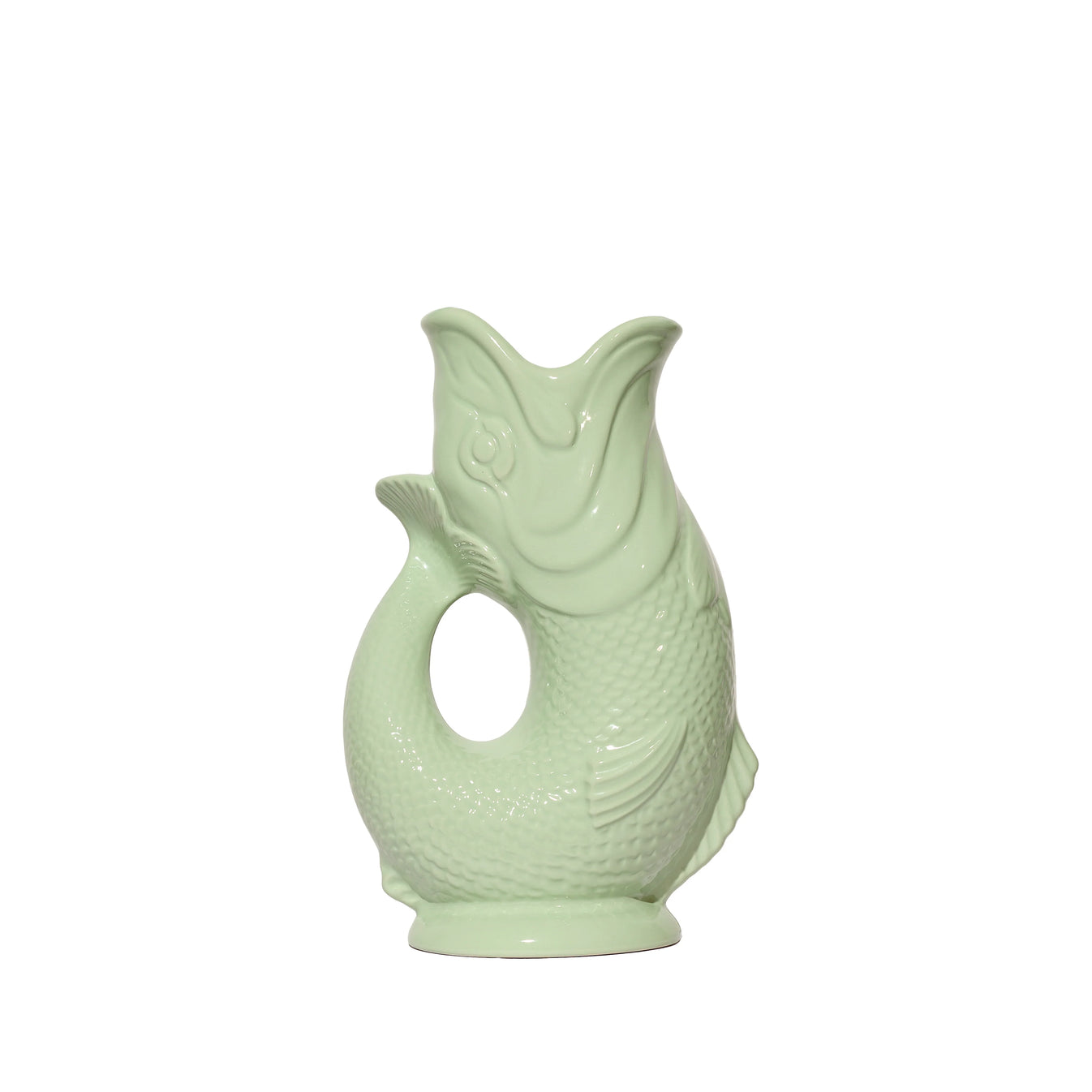 The Original Gluggle Jug’s Fish Gluggle Jug Collection features a pale green ceramic fish-shaped pitcher with textured scales and an open mouth, photographed on white—a classic British design icon.