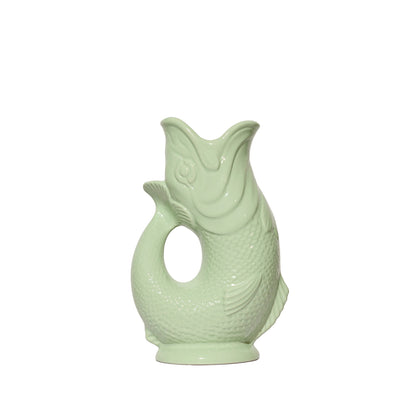 The Original Gluggle Jug’s Fish Gluggle Jug Collection features a pale green ceramic fish-shaped pitcher with textured scales and an open mouth, photographed on white—a classic British design icon.