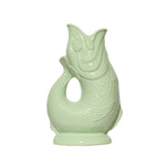 The Original Gluggle Jug Fish Collection features a light green ceramic pitcher shaped like a fish with an open mouth and textured scales—an iconic British design.