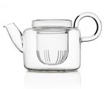 The Ichendorf Milano Piuma Small Teapot with Filter features clear glass, a round handle, short spout, and built-in filter for elegant tea brewing, shown against a white background.