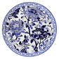 The Pivoines Bleues Dinnerware and Serveware Collection by Gien France features a round porcelain plate with a blue and white floral design of blooming peonies and leaves, bordered by an intricate blue pattern inspired by Gien's prestige archives.