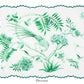 The Secret Garden Table Linen Collection by Aquazzura Casa features a white placemat with green botanical prints—bird, flowers, leaves, butterfly, and dragonfly—plus scalloped edges. Perfect to pair with matching tablecloths or napkins.