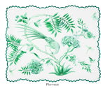 The Secret Garden Table Linen Collection by Aquazzura Casa features a white placemat with green botanical prints—bird, flowers, leaves, butterfly, and dragonfly—plus scalloped edges. Perfect to pair with matching tablecloths or napkins.