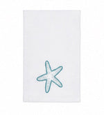 Introducing the Playful Starfish Bath Collection by Haute Home: a white hand towel featuring an elegant blue and white embroidered starfish near the bottom center, expertly crafted from premium linen to enhance your home décor, showcased against a plain white background.