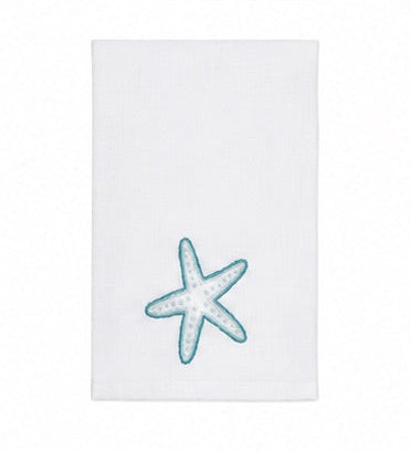 Introducing the Playful Starfish Bath Collection by Haute Home: a white hand towel featuring an elegant blue and white embroidered starfish near the bottom center, expertly crafted from premium linen to enhance your home décor, showcased against a plain white background.