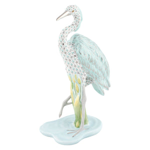 The Herend Reserve Collection Great Blue Heron is a limited edition porcelain figurine featuring pastel blue and green feathers and stands gracefully on a water-inspired base.