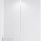 The Zafferano America Poldina Pro L Floor Lamp stands on a white floor by two white cubes against a plain wall, offering cordless convenience and touch dimming.