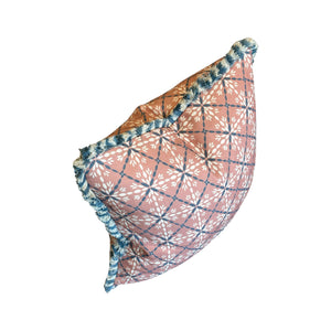 The Porto Pool Pillow by Hive Custom Pillows features a handmade pink and white geometric floral pattern, blue plaid lines, and blue fringe trim on the edges, shown against a white background.