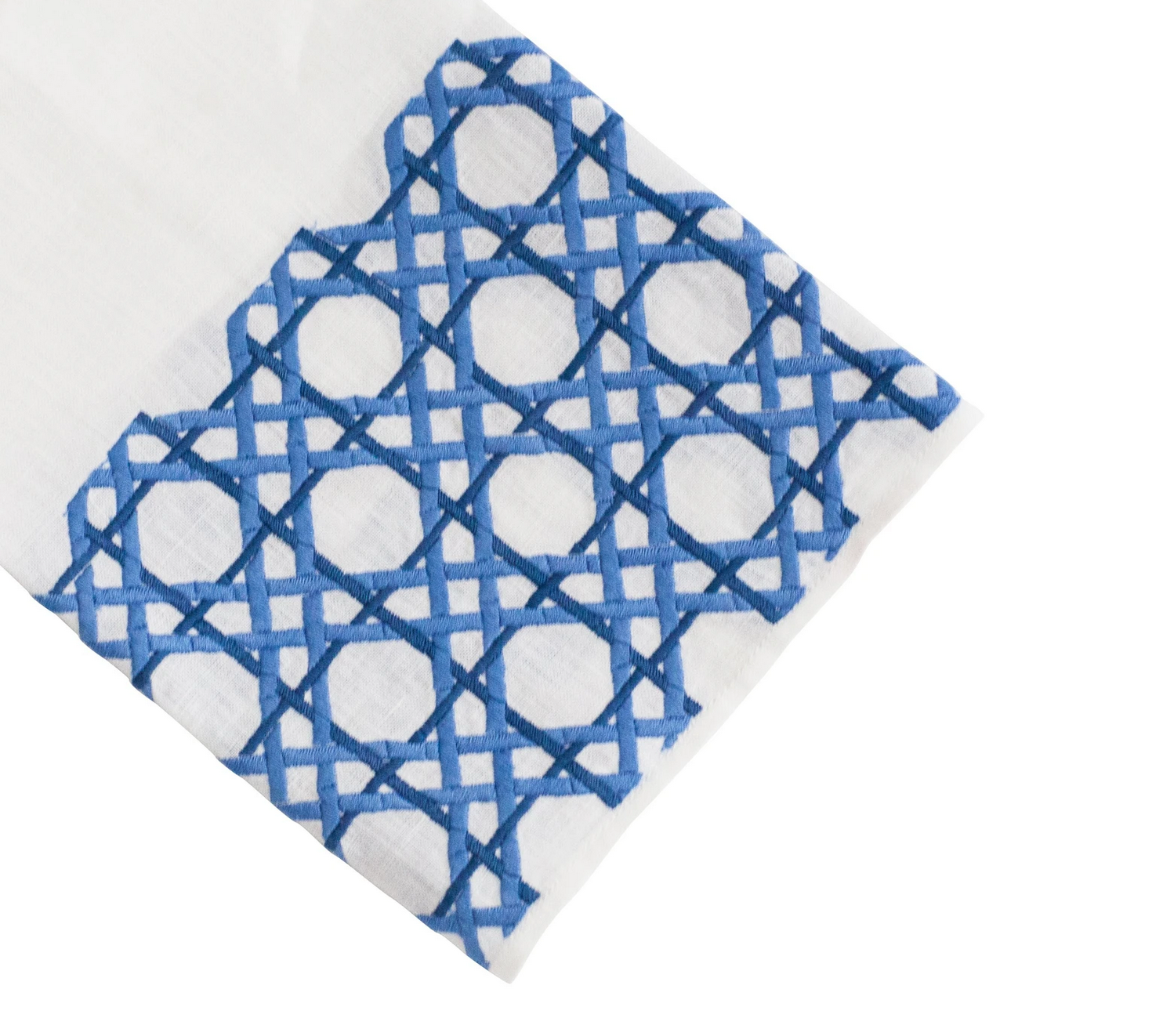 The Cane Bath Collection by Haute Home features white Italian linen fabric adorned with a blue geometric embroidery pattern of interlocking shapes on one end, making it perfect for an elegant tip towel or tissue box cover.