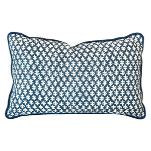 The Burma Indigo Outdoor Lumbar Pillow by Associated Design features a navy and white geometric leaf pattern with a blue border, combining high-quality materials for stylish comfort in any space.
