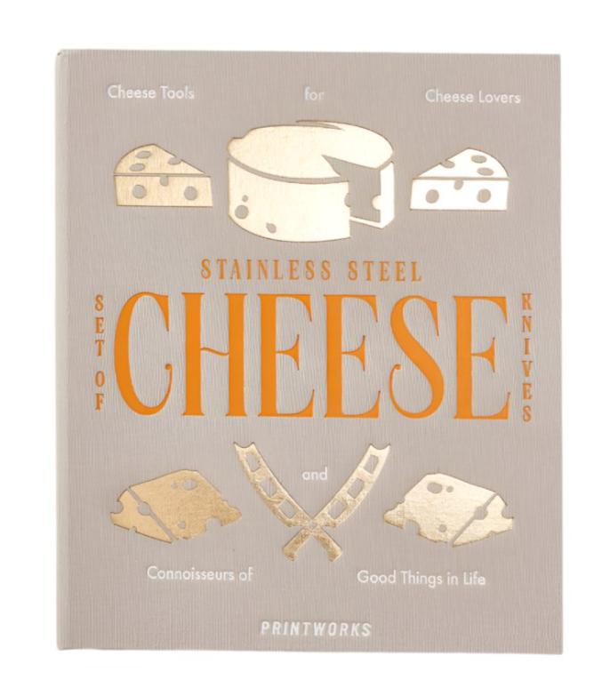 The PrintWorks Cheese Tool Set features stainless steel utensils in a boxed kit with charming illustrations—an ideal gift for cheese lovers and connoisseurs.
