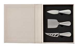 The PrintWorks Cheese Tool Set features stainless steel-handled knives arranged in foam cutouts inside a beige box with an empty compartment—an elegant addition to any cheese board kit.