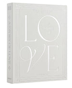 The PrintWorks "A Story of Love Wedding Album" is a hardcover photo album with embossed white text and decorative borders on a light gray cover, ideal for preserving your wedding day memories.