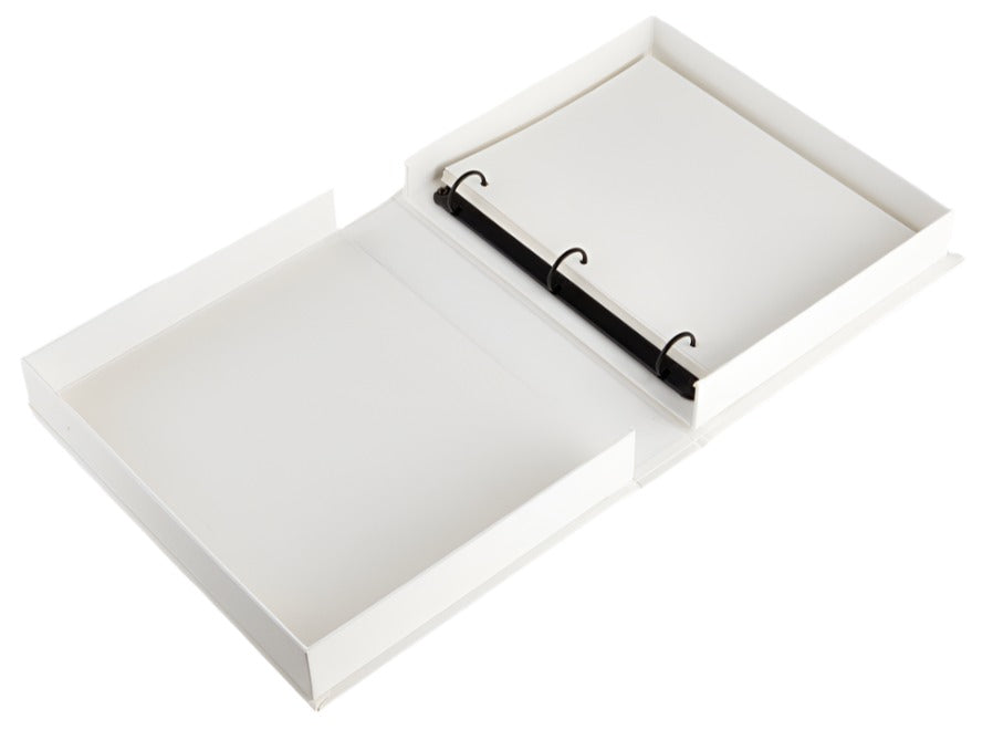 The PrintWorks A Story of Love Wedding Album is an open white three-ring binder with blank pages, photographed from above—ideal for creating your own wedding photo album or preserving memories on high-quality paper.