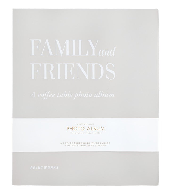 Front cover of the Family and Friends Photo Album by PrintWorks, showcasing a minimalist beige design with white text and stylish photo storage on high-quality black photo paper.