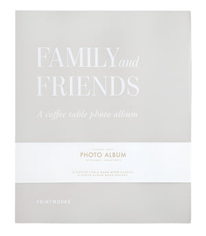 Front cover of the Family and Friends Photo Album by PrintWorks, showcasing a minimalist beige design with white text and stylish photo storage on high-quality black photo paper.