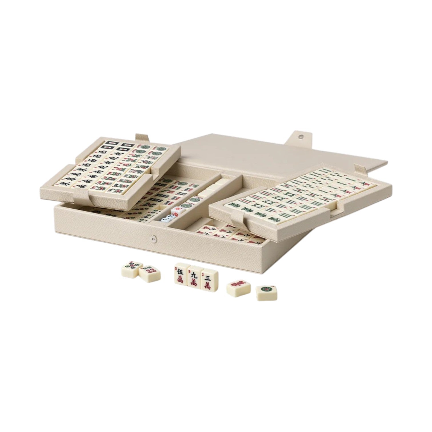 The PrintWorks Mahjong Reverra Game Set features a beige faux leather case with neatly organized American Mahjong tiles, some trays partially open, and a few tiles scattered across the surface.