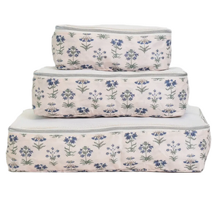The TRVL Design Luxe Packing Cube Set of 3 features rectangular fabric bags in blue floral patterns, stacked by size with zipper closures—ideal lightweight luggage organizers for travel.