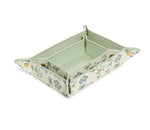 The Luxe Saffiano Tray Set Collection by TRVL Design features a rectangular travel valet tray with a green and white striped interior, floral-patterned exterior, and snap corner buttons—an ideal pocket-sized organizer for on-the-go use.