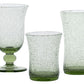 Three green-tinted pieces from Juliska’s Provence Basil Drinkware Collection, featuring bubbled texture and unique shapes, are displayed on a white background.