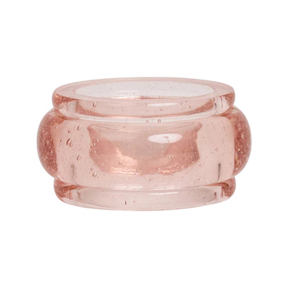 The Provence Napkin Ring Collection by Juliska features translucent, light pink glass rings with rounded edges and tiny air bubbles, reminiscent of bubbly glassware—perfect for Provence-inspired table settings. Displayed on a white background.
