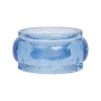 A translucent blue resin napkin ring from the Provence Napkin Ring Collection by Juliska features a wide band and small air bubbles inside, echoing the look of bubbly Provençal glassware.