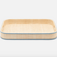 Rectangular woven tray with raised sides, light blue leather trim, and raffia details from Blue Pheasant’s Gable Natural/White Barware Collection on a plain white background.