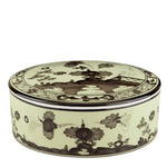A round porcelain box with lid from the Oriente Italiano Bario Decor Collection by Ginori 1735, featuring intricate black floral and geometric patterns on a cream background reminiscent of classic Oriente Italiano dinner plates.