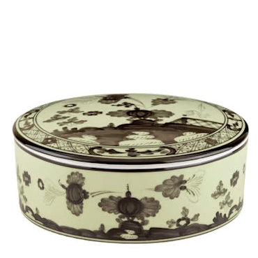A round porcelain box with lid from the Oriente Italiano Bario Decor Collection by Ginori 1735, featuring intricate black floral and geometric patterns on a cream background reminiscent of classic Oriente Italiano dinner plates.