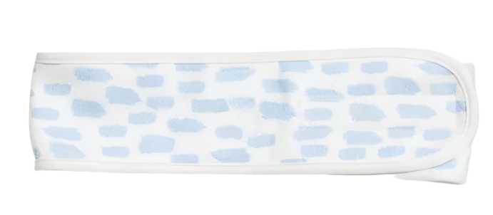 The Weezie Towels Spa Headband is a white microfiber headband with irregular light blue rectangles, adjustable Velcro, and is shown laid flat on a white background.