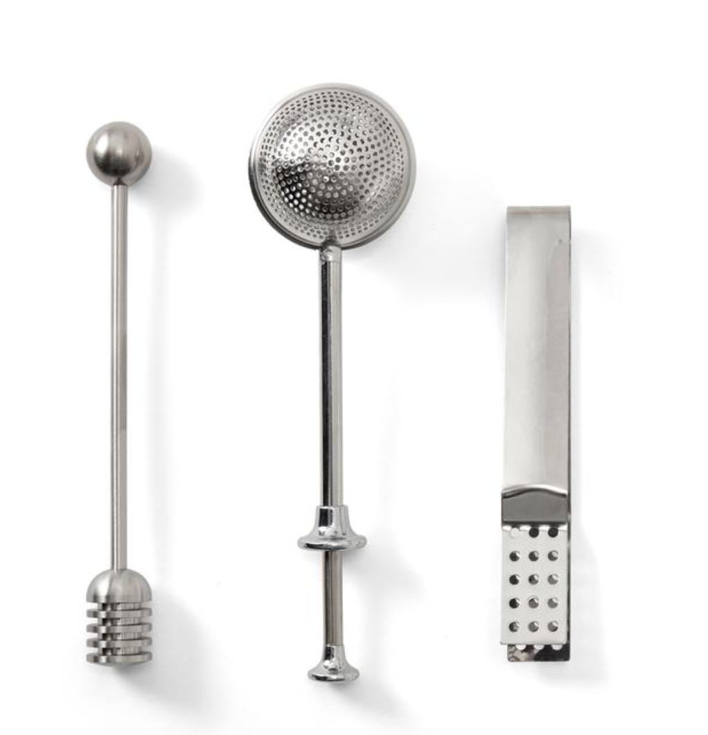 The PrintWorks Tea Tool Set includes a honey dipper, perforated sphere tea infuser, and flat-edged tongs with dotted grip, all crafted from stainless steel and displayed on a white background.