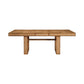 The Made Goods Dariel Extension Dining Table features a rectangular wooden top with natural burl patterns, a rustic finish, and two wide legs joined by a horizontal support beam.