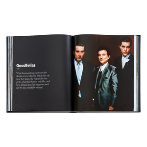 An open copy of "Martin Scorsese: A Retrospective" by Graphic Image shows a page on "Goodfellas," featuring a quote on the left and a photo of three suited men on the right, highlighting this cinema classic.