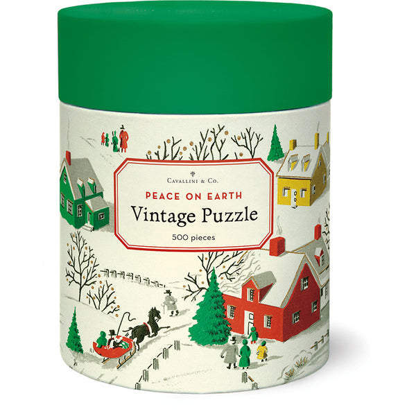 The Cavallini & Co. Peace On Earth 500 Piece Puzzle by Cavallini Papers and Co comes in a green cylindrical container labeled "Peace on Earth Vintage Puzzle" and showcases a snowy village illustration. This charming holiday season puzzle features vintage imagery from the Cavallini archives, making it a perfect nostalgic addition to your festive activities.