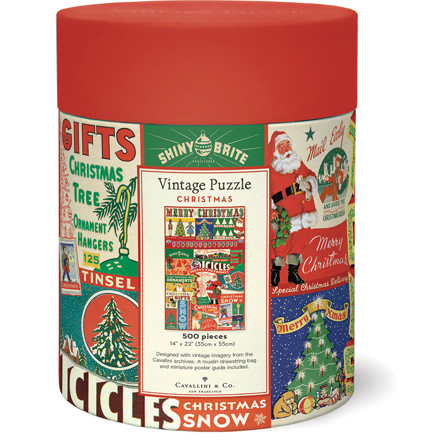 A cylindrical box with vintage festive designs holds the Vintage Christmas 500 Piece Puzzle by Cavallini Papers and Co—an ideal holiday gift for puzzle lovers.